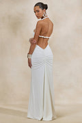 Elirae | Robe longue blanche à encolure asymétrique avec bretelle torsadée et haute fente sur le devant